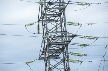 Electric post with wires. Transmission tower. Close up high voltage power lines. High voltage electric transmission pylon tower.