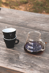 coffee cup on a wooden table/v60 black coffee outdoors
