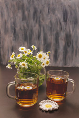 Chamomile tea. Fresh flowers, summer hot drink concept. Alternative medicine, lifestyle