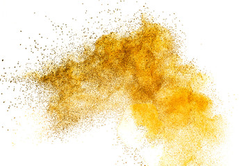 Orange powder splattered on white background.Abstract design of color dust cloud against white background.
