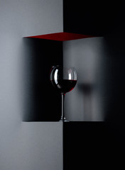 Glass of red wine on a black background. Copy space.