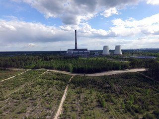Fototapeta na wymiar Chimney of power plant in the forest. Drone aerial view. Near Kiev,Ukraine