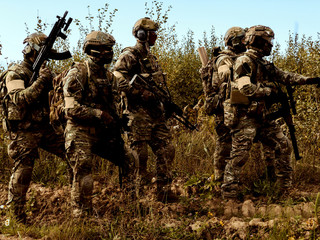 Military swat team members during operation. Combat squad in position.