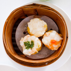 Chinese dumpling in a bamboo steamer box