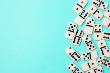 Dominoes on a blue background with copyspace