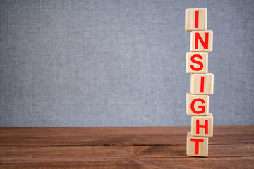 Word INSIGHT text on wooden cubes on dark wooden backround. Business, Marketing, Growth concept.