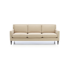 Classic formal sofa for three seats, isolated.Three seats cozy color fabric sofa isolated on white.
