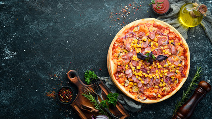 Pizza with sausage and corn. Top view. free space for your text. Rustic style.