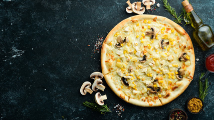 Hawaiian pizza with chicken, pineapple and mushrooms on the table. Rustic style. Top view.