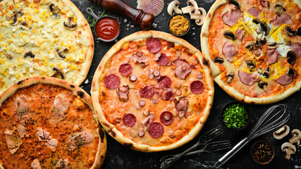 Background Pizza. Set of delicious pizzas with bacon, cheese and mushrooms. Top view.