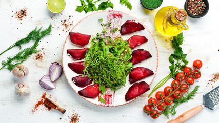 Beetroot salad with arugula and cheese. Top view. free space for your text. Rustic style.