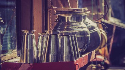 Organised metal cups with metal pot in tray