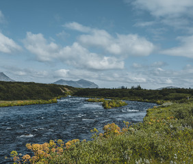 Glacial River Bruara leading towards waterfall bruarfoss in Iceland., Beautiful summer view during midnight sun with blue sky and clouds. Southwest Iceland during Summer.