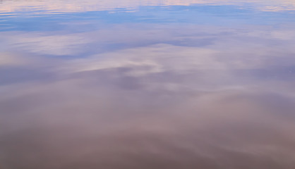 blurred colored background - the evening sky is reflected in the water