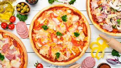 Homemade pizza with chicken, tomatoes and corn. Top view. free space for your text. Rustic style.