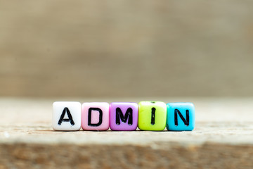 Colorful bead with black letter in word admin (Abbreviation of administration) on wood background