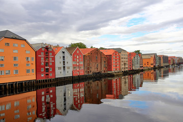 Bakklandet in Trondheim, Norway. This idyllic neighborhood on the east side of the Nidelva river features colorful old wooden buildings. Architecture, buildings, travel and photography concept.