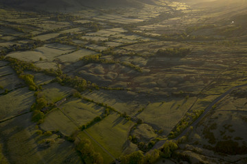 British countryside aerial view with patchwork fields at dawn