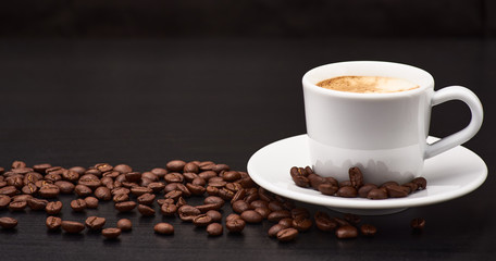 A cup of coffee is on the table.