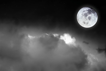 Naklejka na ściany i meble Black and white image of blurry cosmic clouds and bright full moon with stars on dark sky background. Image of moon furnished by NASA.