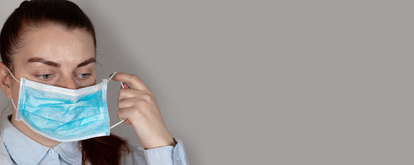 Young girl in a medical mask feels bad. Sore throat, illness. Coronavirus, covid 19