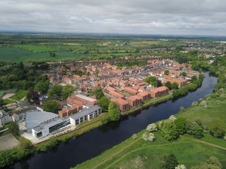Fototapeta na wymiar The historic market town of Yarm in North Yorkshire from above by drone showing the River Tees 