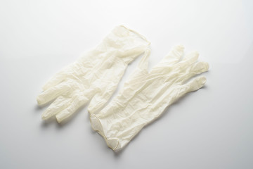 Beige latex gloves, on white background. Protector to prevent contagion.