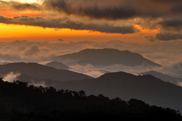 Costa Rica sunset landscape. Hills of Tapantí nationl park cloud forest, Costa Rica. Tropical mountains with white storm clouds. Rainy day in the forest. Tropic landscape in Cetral America, sunset.