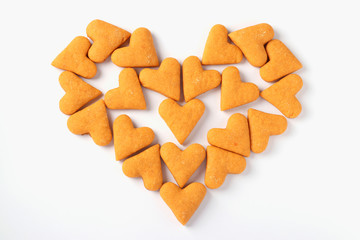 Heart made from ginger cookies in the shape of hearts on a white background, Concept for Valentine's Day, View from above