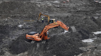 Workers and machinery - zero-cycle construction of the foundation of an entertainment center