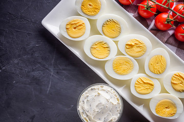 boiled chicken eggs on a dark stone background