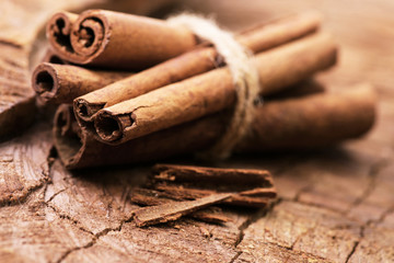 Cinnamon sticks on a wooden background