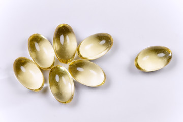 Vitamin D3, golden, yellow vitamin capsules, high quality on a white background