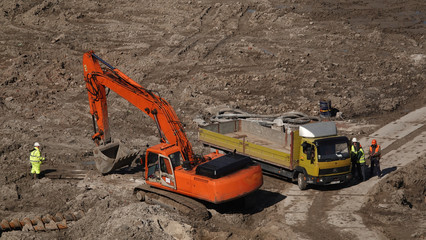 Workers and machinery - zero-cycle construction of the foundation of an entertainment center
