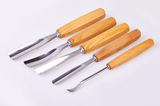  Set of wooden chisels for carving wood, sculpturing tools on white background. 
