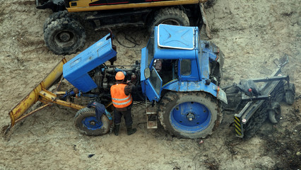 Workers repair equipment on the construction of the zero cycle foundation of the entertainment center