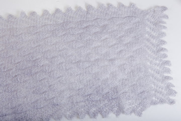 top view on handmade openwork binding gray, knitted, woolen scarf with pattern