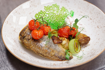 Fried walleye fillet with potatoes, leek and mushrooms