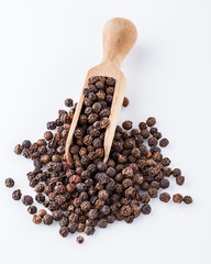 fragrant black pepper on white acrylic background