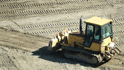 Tractors and excavators work on the construction of the foundation zero cycle