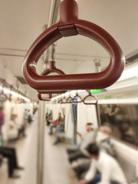 Close up of empty handrails in a Delhi metro train, Handle hand straps in public transportation for passenger safety. Brown hanging handhold for standing passengers in a modern metro train.
