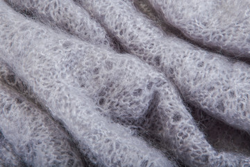 top view macro folded openwork binding gray, knitted, woolen shawl with pattern