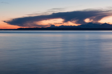 Evening Olympic park mountain silhouette, evening sea and clouds in Picnic Point area, WA, USA