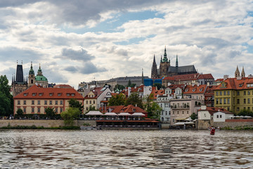 Fototapeta premium Scenic panorama cityscape view of Moldava river boat Prague in Czech Republic.