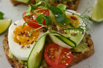 Healthy Breakfast with Wholemeal Bread Toast and Egg with Green Salad, Avocado and Peas.