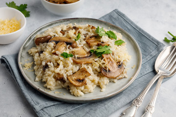 A dish of Italian cuisine - risotto from rice and mushrooms.