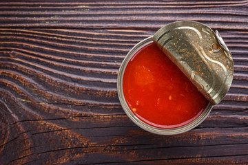 juicy canned tomatoes on wooden rustic background