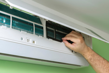 Male technician repairing and diagnosing air conditioners. Husband for an hour