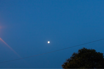 Sunrise with the moon in the background.