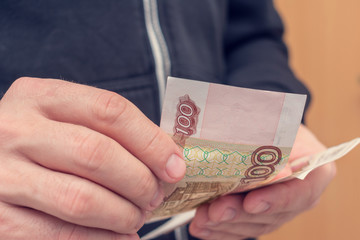 Man counts the money, Russian rubles, man's hands, closeup
